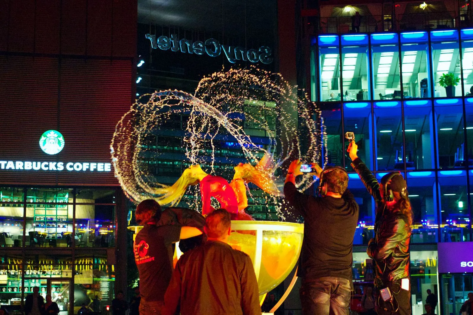 Dynamic fountain performance art captured at night with vibrant lighting.